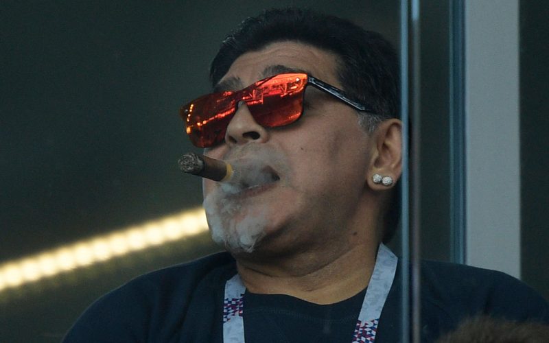 Argentina's football legend Diego Maradona smokes a cigare as he attends the Russia 2018 World Cup Group D football match between Argentina and Iceland at the Spartak Stadium in Moscow on June 16, 2018. (Photo by Juan Mabromata / AFP) / RESTRICTED TO EDITORIAL USE - NO MOBILE PUSH ALERTS/DOWNLOADS        (Photo credit should read JUAN MABROMATA/AFP/Getty Images)